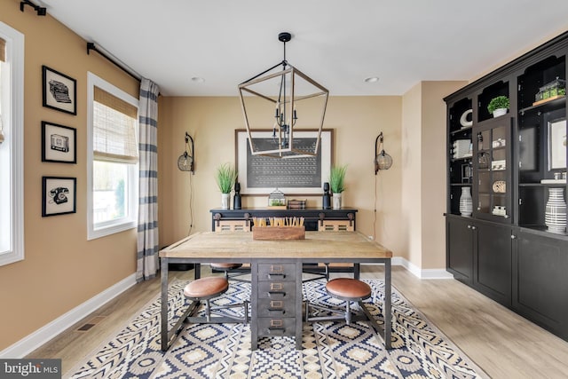 interior space featuring light hardwood / wood-style floors and an inviting chandelier