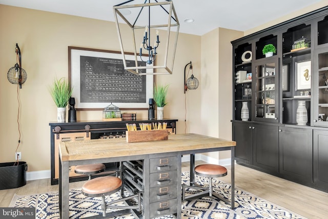 dining room with bar area and light wood-type flooring