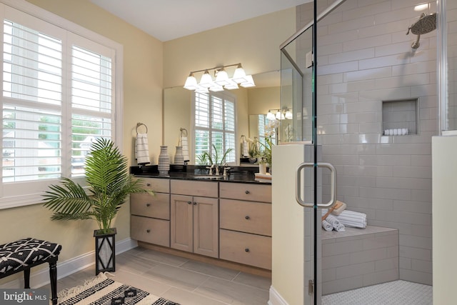 bathroom featuring tile flooring, a shower with door, and vanity with extensive cabinet space