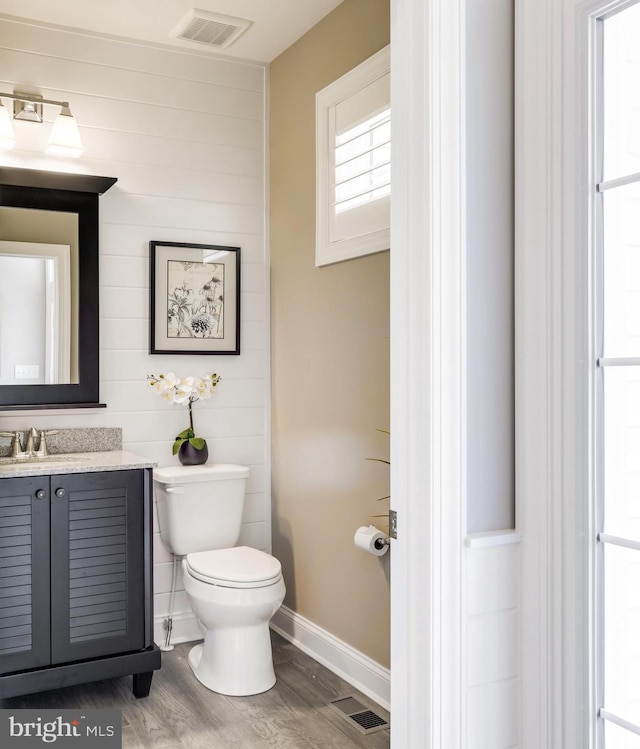 bathroom featuring hardwood / wood-style floors, toilet, and vanity