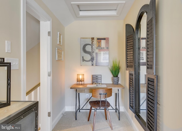 office with light colored carpet and vaulted ceiling