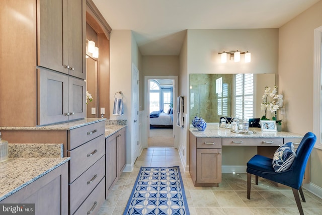 bathroom with tile flooring and vanity with extensive cabinet space