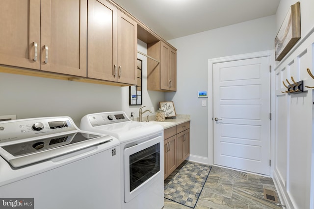 washroom with cabinets, independent washer and dryer, sink, and tile flooring