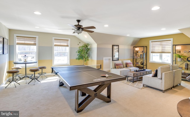 recreation room featuring ceiling fan, lofted ceiling, and light colored carpet