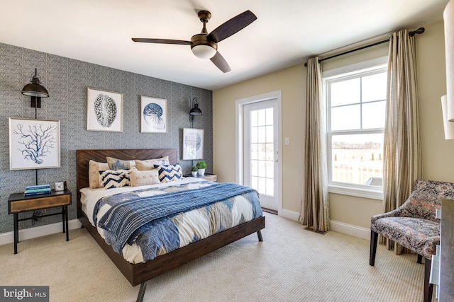 carpeted bedroom with ceiling fan and multiple windows