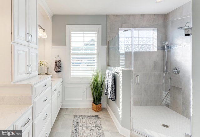 bathroom featuring vanity, tile floors, and walk in shower