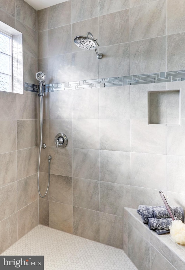 bathroom with a tile shower