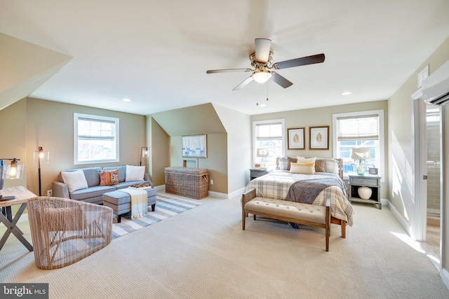 carpeted bedroom with multiple windows, ensuite bath, and ceiling fan