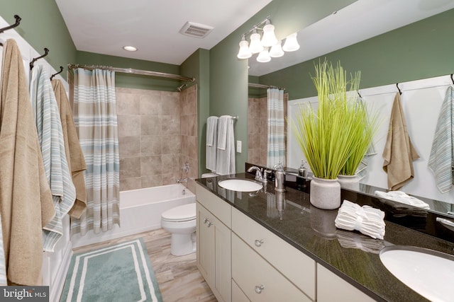 full bathroom featuring toilet, shower / tub combo, double sink, a chandelier, and oversized vanity