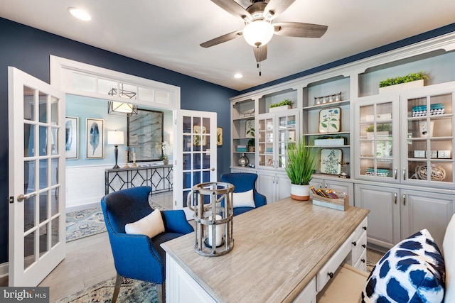 home office with ceiling fan, light wood-type flooring, and french doors