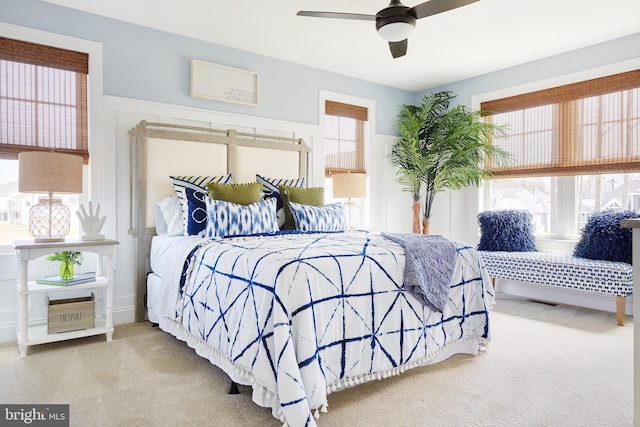 bedroom with light carpet and ceiling fan