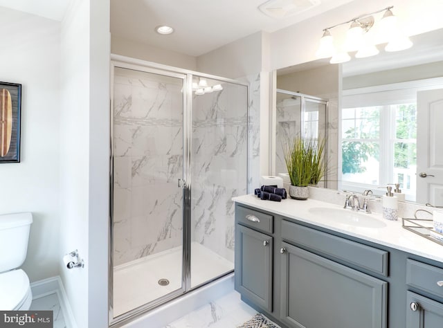 bathroom with a shower with shower door, toilet, tile floors, and vanity with extensive cabinet space