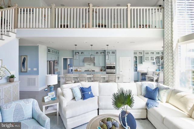 living room featuring light hardwood / wood-style floors and a high ceiling