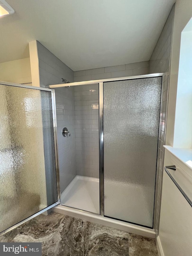 bathroom with a shower with shower door