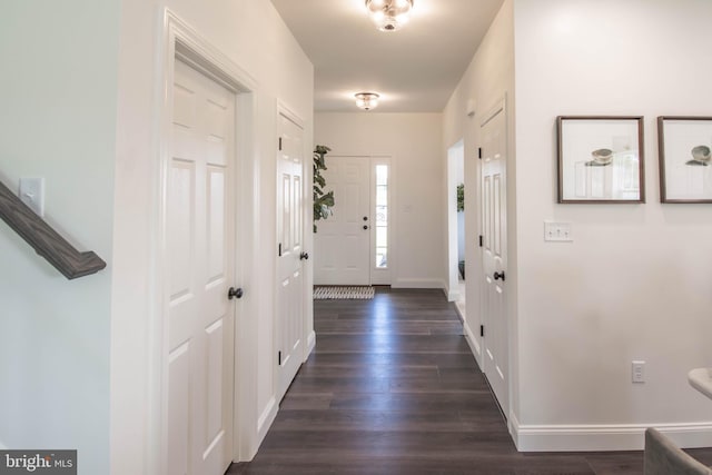 hallway with dark hardwood / wood-style flooring