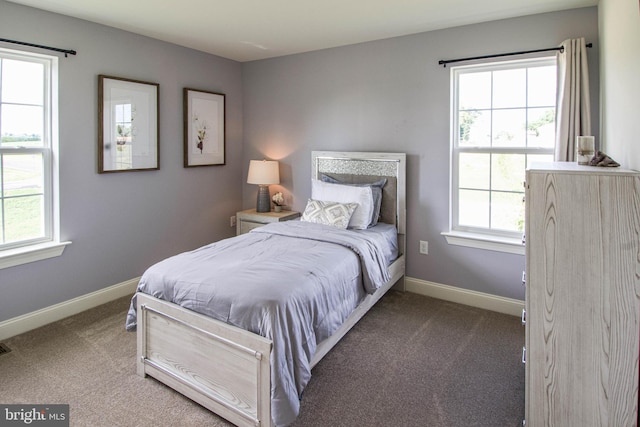 bedroom with dark colored carpet