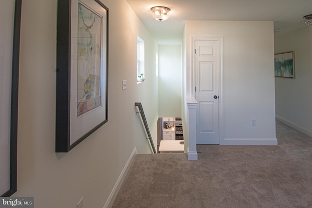 hallway featuring dark colored carpet