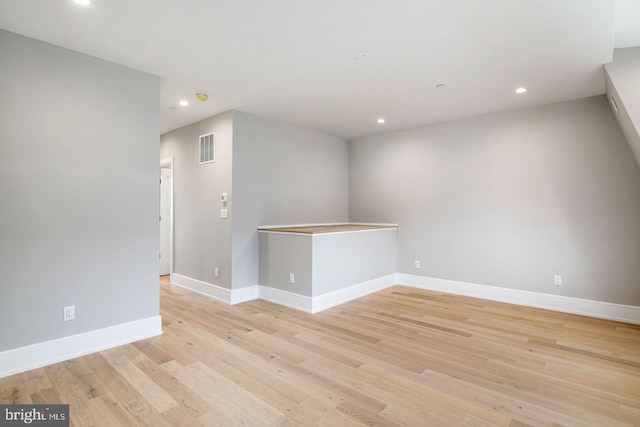 unfurnished room with light hardwood / wood-style floors