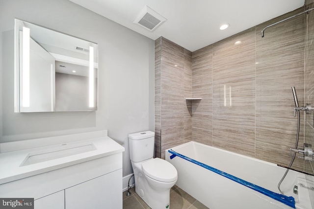 full bathroom featuring tiled shower / bath combo, vanity, tile flooring, and toilet