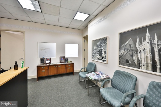 home office featuring dark carpet and a paneled ceiling