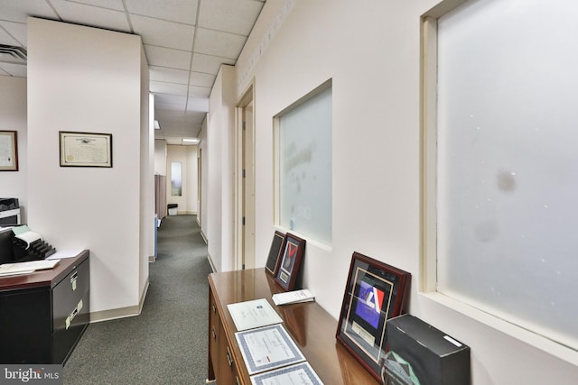 home office with dark carpet and a drop ceiling