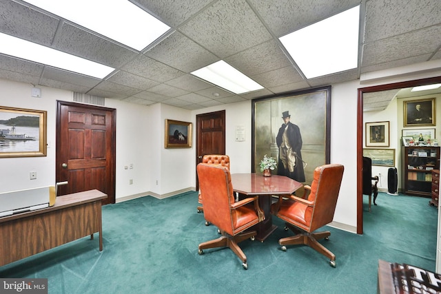 dining room with a drop ceiling and dark carpet