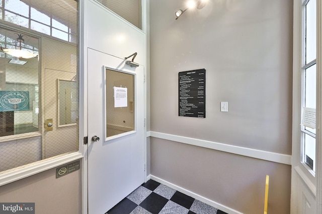 entryway with dark tile floors