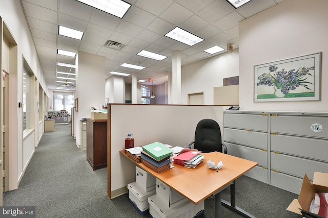 office space featuring dark colored carpet and a drop ceiling