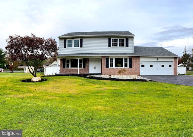 front facade with a front yard and a garage