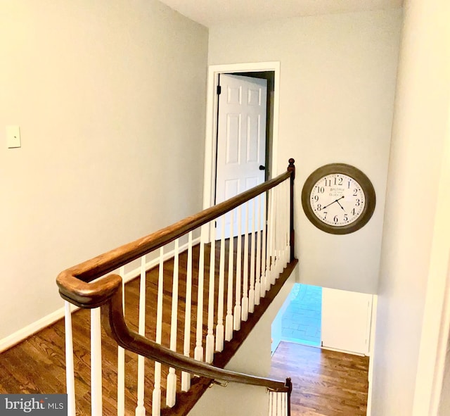 stairs with dark wood-type flooring