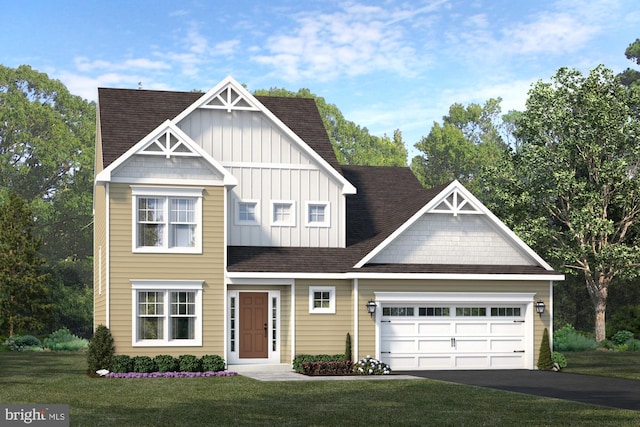 view of front of home with a front lawn and a garage