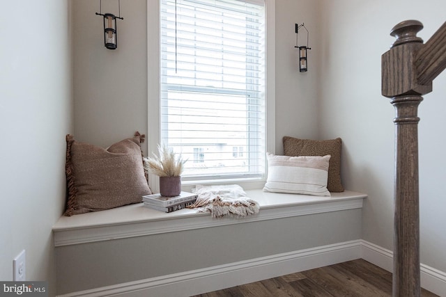 sitting room featuring plenty of natural light and dark hardwood / wood-style floors