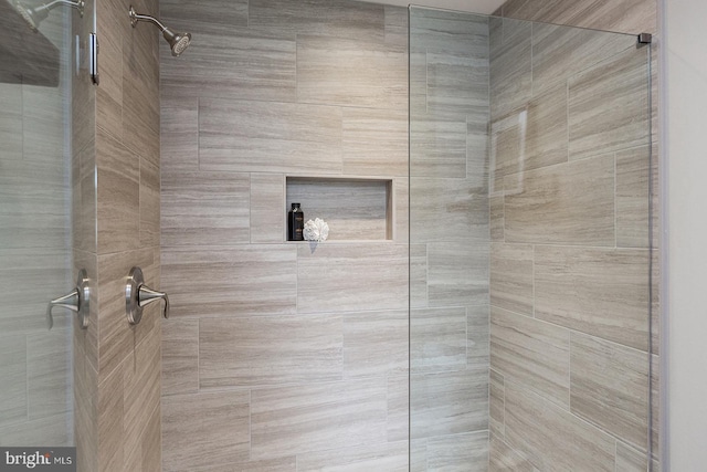 bathroom with a tile shower