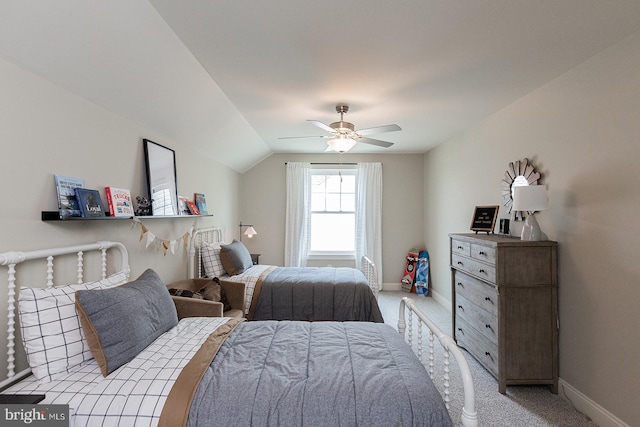 carpeted bedroom with ceiling fan and vaulted ceiling