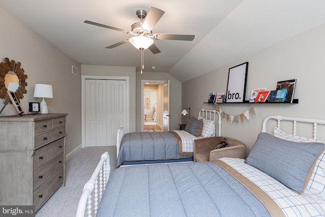 carpeted bedroom featuring a closet, lofted ceiling, and ceiling fan