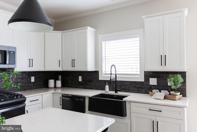 kitchen featuring white cabinetry, appliances with stainless steel finishes, tasteful backsplash, and sink