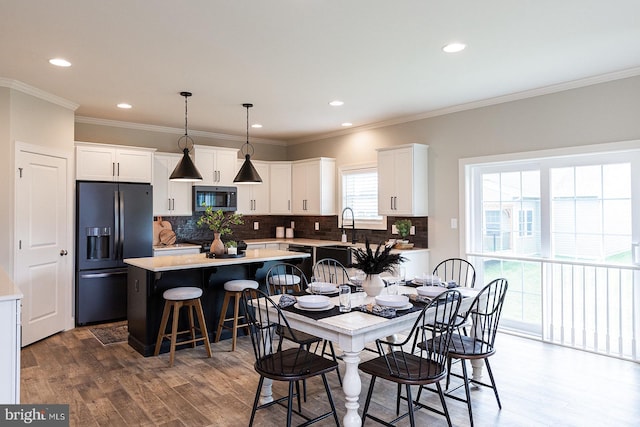 dining space with ornamental molding and dark wood-type flooring