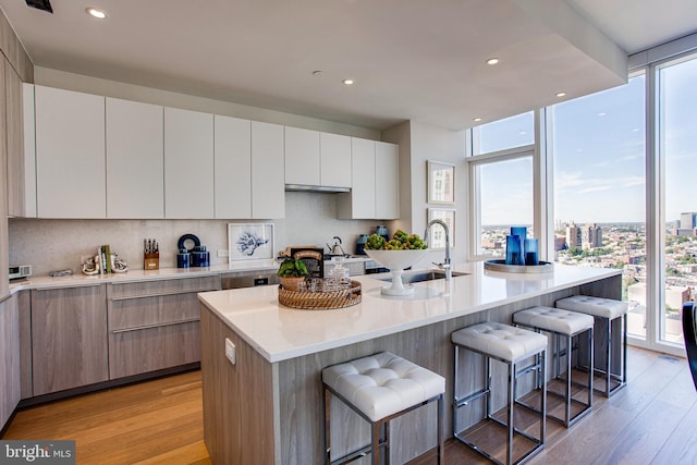 kitchen featuring a kitchen bar and a healthy amount of sunlight