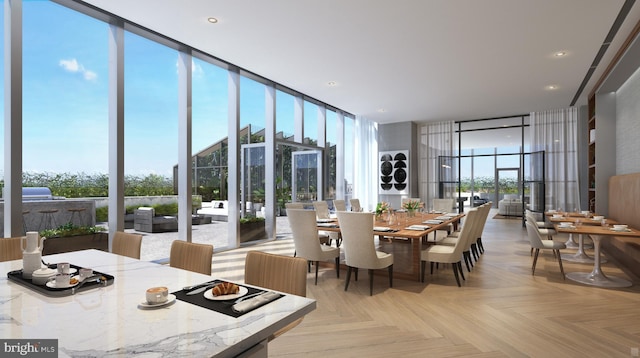 dining space with light parquet flooring and a wall of windows