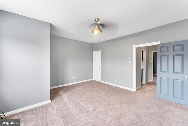 spare room featuring ceiling fan and light colored carpet