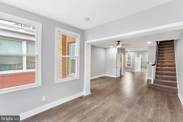 interior space with ceiling fan and dark hardwood / wood-style flooring