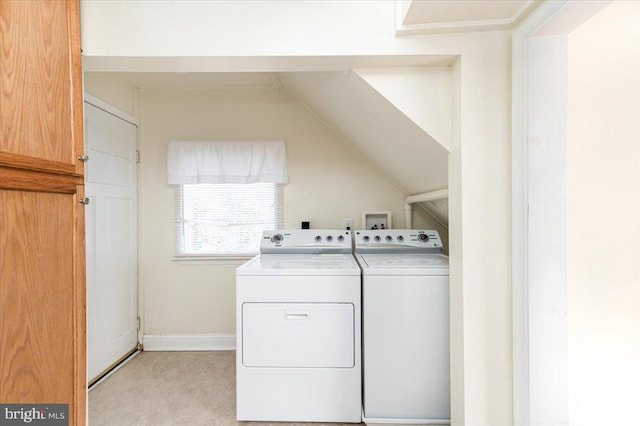 clothes washing area featuring washer hookup, light colored carpet, and washer and dryer