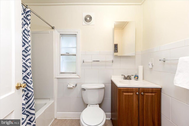 full bathroom with tile walls, toilet, and vanity