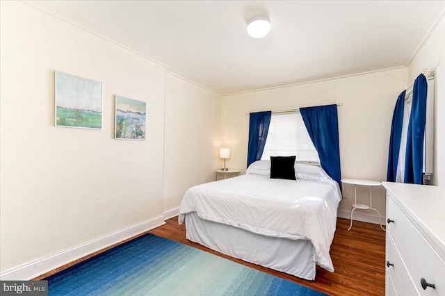 bedroom with dark hardwood / wood-style flooring