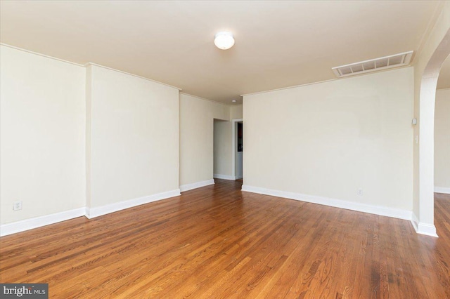 spare room with crown molding and hardwood / wood-style floors