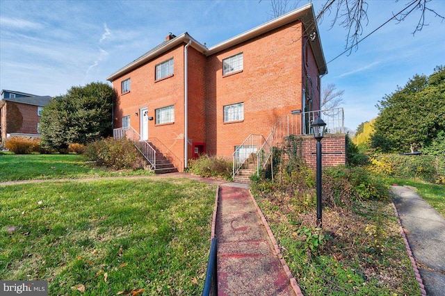 view of side of home featuring a yard