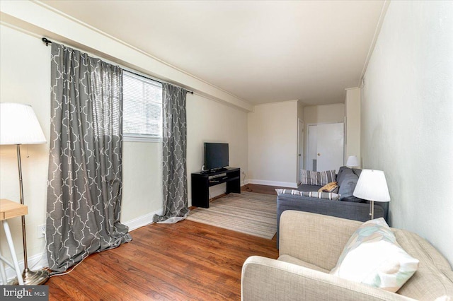 living room with dark hardwood / wood-style floors and crown molding