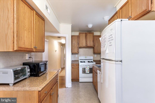 kitchen with white appliances and backsplash