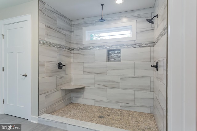 bathroom with tiled shower