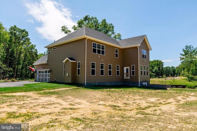 rear view of property featuring a yard